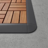 Wooden floor corner piece with gray edge, smooth finish, robust construction.