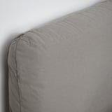 Close-up of upholstered beds headboard, showcasing soft, textured fabric; draped against a white wall, demonstrating quality craftsmanship.