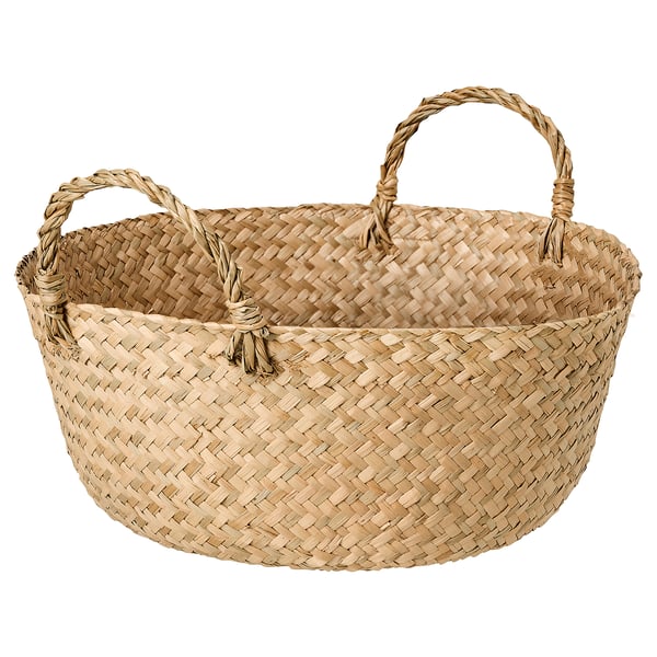 Handwoven basket named SANDJORD in natural sedge color, featuring a circular shape with two twisted handles for carrying. A rustic, natural design.