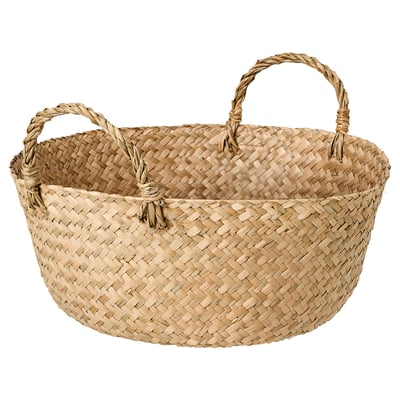 Handwoven basket named SANDJORD in natural sedge color, featuring a circular shape with two twisted handles for carrying. A rustic, natural design.