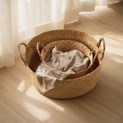 Handwoven SANDJORD baskets, large & small, natural sedge, organized, earthy tones, wooden floor.