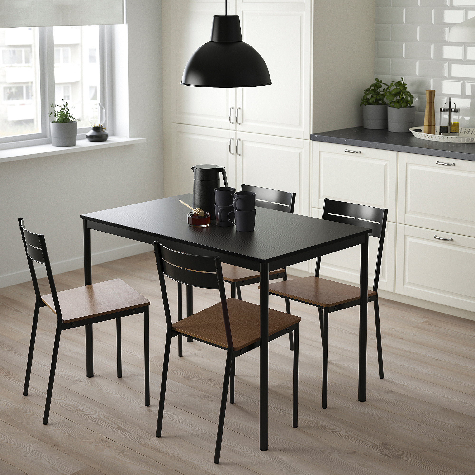 Modern black sandberg dining set with sleek table and minimalist chairs, perfect for small spaces.