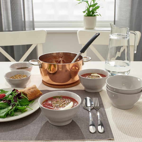 Earthy dinnerware, soup, utensils.