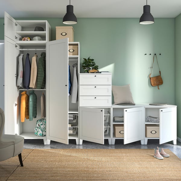 Modern closet with drawers and shelves, filled with clothes and accessories, featuring knobs and storage boxes.