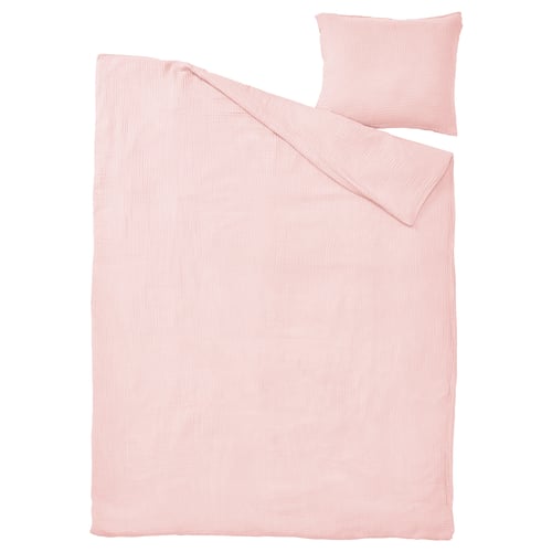 A SCHERSMIN bedding set in light pink, featuring a flat duvet cover and a pillowcase, made of 100% organic cotton, with a soft, wavy texture.