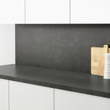 Modern kitchen with SIBBARP black cleanable wall panel & countertop.