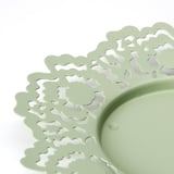 Light green metal candle dish with intricate, laser-cut floral patterns for a modern twist on traditional craftsmanship.