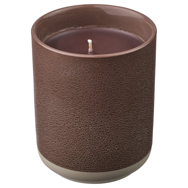 A SILKESTRÄD scented candle in a brown ceramic container with a leather-like texture. The candle has a single wick and is unlit.