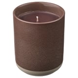 A SILKESTRÄD scented candle in a brown ceramic container with a leather-like texture. The candle has a single wick and is unlit.