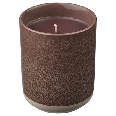A SILKESTRÄD scented candle in a brown ceramic container with a leather-like texture. The candle has a single wick and is unlit.