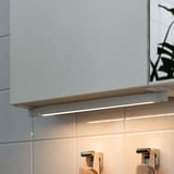 Under-cabinet led light provides soft illumination for bathroom work areas. Modern and functional, enhancing visibility and ambiance.