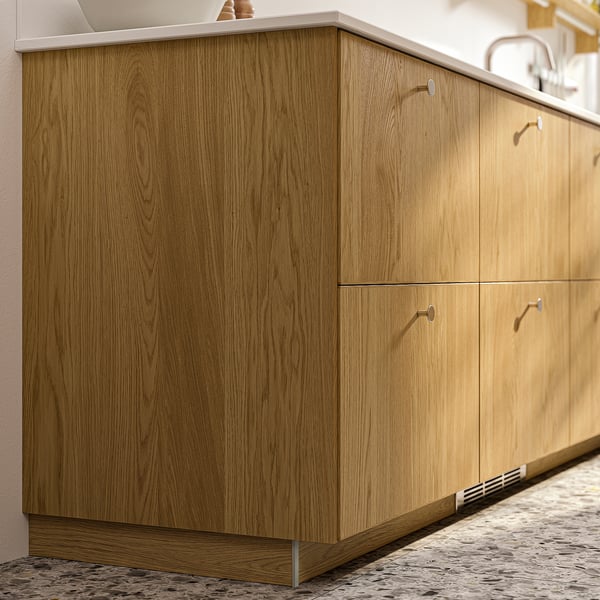 Wooden kitchen cabinet in warm oak with minimalist design.