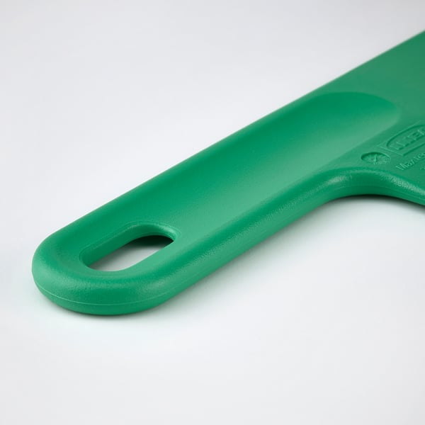A close-up of a green baking spatula. Shows the handle with a comfortable grip and a small hole for hanging.