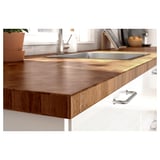 Modern kitchen counter with stainless steel sink, featuring SKOGSÅ wooden worktop in brown with silver handles.