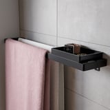 Modern black shelf by SKOGSVIKEN, made of plastic, holding items in bathroom.