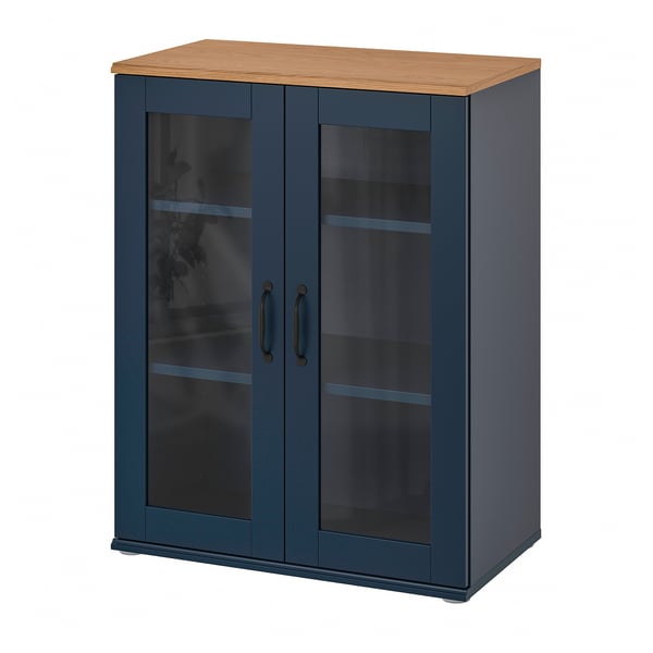 The SKRUVBY cabinet is a tall, teal unit with double glass doors and wooden top. It has a classic design with metal handles.
