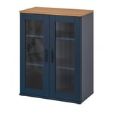 The SKRUVBY cabinet is a tall, teal unit with double glass doors and wooden top. It has a classic design with metal handles.
