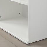 Close-up of SKRUVBY cabinets corner. Clean, white finish. Smooth edges. Slots for adjustable shelving.