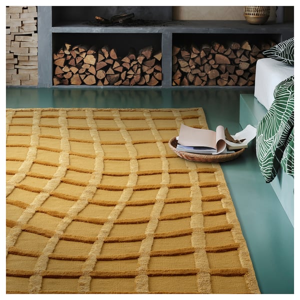 Mustard yellow rug with net-like texture, adding rustic charm.