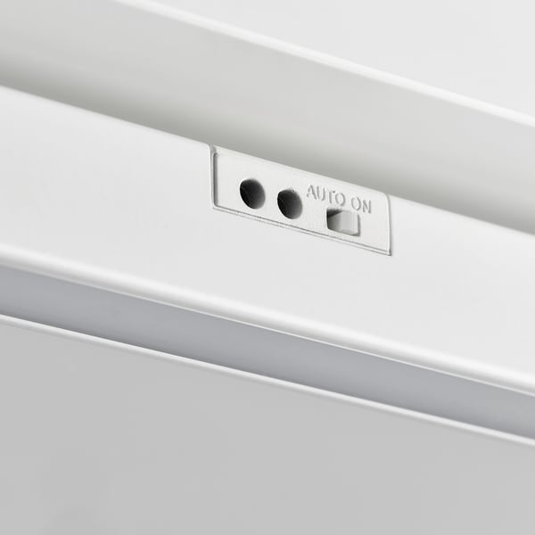 A close-up of a sleek, modern white led light fixture, showcasing its clean design and metallic components, indicating high-quality construction.