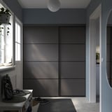 Gray shelving unit dominates blue hallway, console table with bag and headphones.