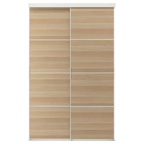 Depicts a SKYTTA light brown wooden sliding door with a minimalist design and modern aesthetic.