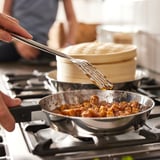 Cooking with SLÄTROCKA pan on gas stove, handle detached, steam rising.