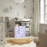 SMÅSTAD changing table in light purple with storage, ocean-themed wallpaper, and nearby crib.