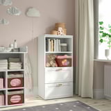 Kids nursery with SMÅSTAD bookcase, shelves, drawers, colorful containers, books, teddy bear, window, curtains, rug. Reduced to 94 characters.