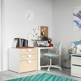Childs study area with white desk, blue chair, and colorful decor. Includes books, laptop, and clock.
