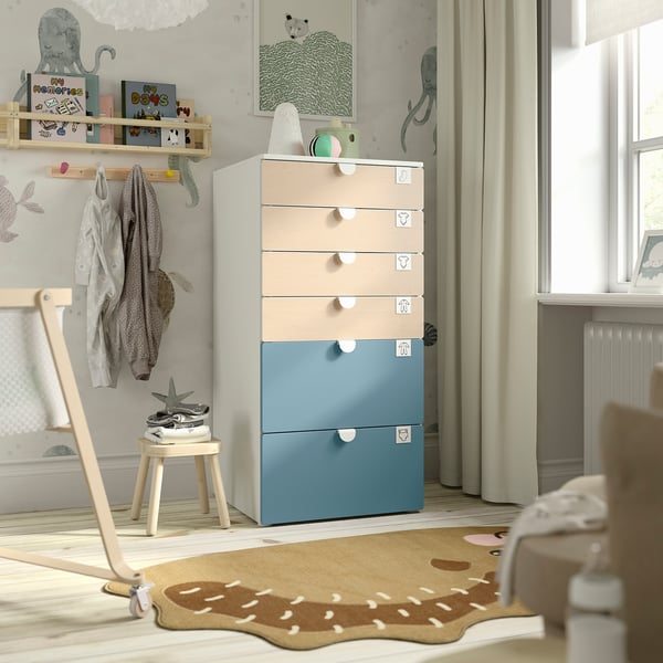 Childs room with colorful SMÅSTAD drawers. Tall, pastel storage with light wood accents, next to a window.