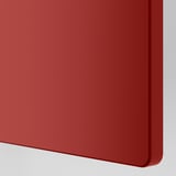 Bright red smooth surface of a kids wardrobe showing quality finish and rounded edges.