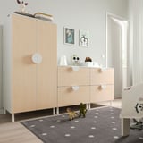 Kids room with SMÅSTAD wardrobe, chest, scattered toys, and polka-dot rug.