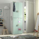 Green SMÅSTAD wardrobe with magnets, coat, toys, emphasizing child-friendly design.
