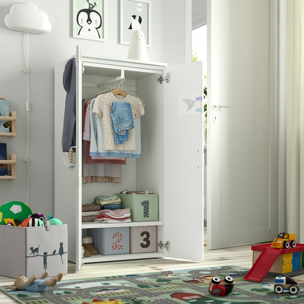 Kids wardrobe with clothes & storage bins, designed for small children to access independently.