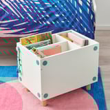 White storage box under a bed, holding colorful books. The box has turquoise circular handles and adjustable legs for different bed heights.