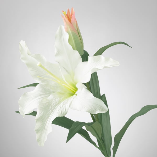 Artificial white lily with green leaves; realistic, crafted with detailed petals, stem, and veins.