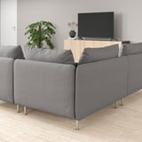 Modern living room with a SÖDERHAMN gray sofa, wooden tv stand, flat screen tv, and a tall indoor plant.