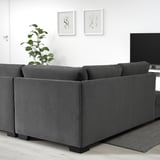 Modern dark gray SÖRVALLEN sofa, minimalist style, fits well in spacious living rooms.