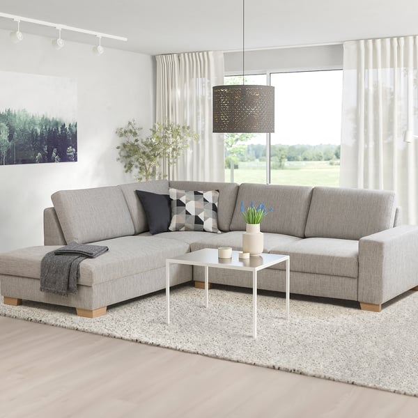 SÖRVALLEN sectional sofa, light grey, modern scandinavian design. L-shape, firm seat, angled back. Bright room with plants and white coffee table.