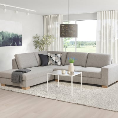 SÖRVALLEN sectional sofa, light grey, modern scandinavian design. L-shape, firm seat, angled back. Bright room with plants and white coffee table.