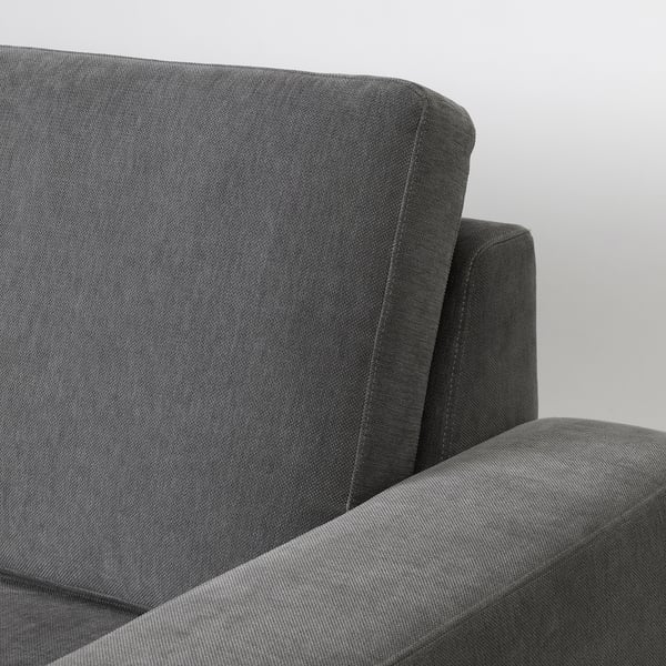 Close-up of SÖRVALLEN sofas armrest, showcasing quality fabric and sturdy frame.