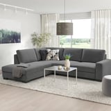 Grey sectional sofa with plush cushions in cozy living room.