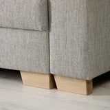 Sofa base detail: two wooden pieces with a light finish, seamlessly supporting sofas sleek, patterned fabric.
