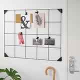 Wall-mounted memo board with clips holding various papers, photos, and notes; ideal for organizing and displaying important information.