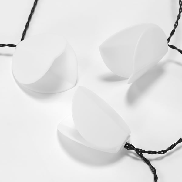 Three solar lights hang on braided cable, diagonal on white background.