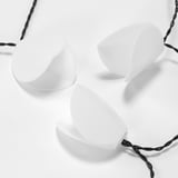 Three solar lights hang on braided cable, diagonal on white background.