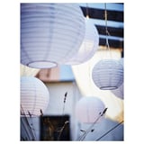 Multiple hanging lanterns of light purple color in various sizes decorate an outdoor setting, emitting a serene ambiance.