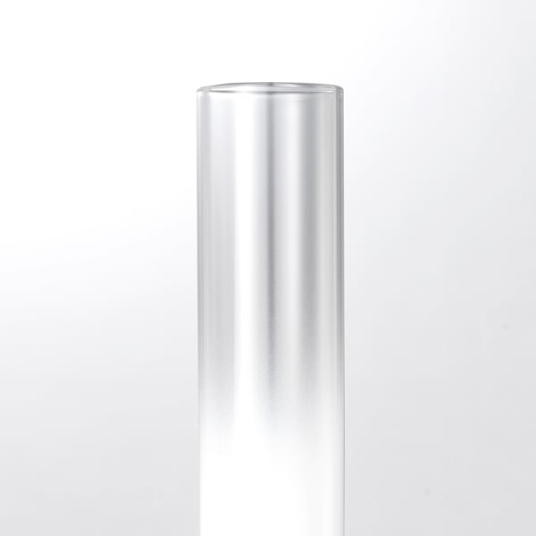 Sleek, cylindrical glass lamp, exuding modern elegance and simple design.