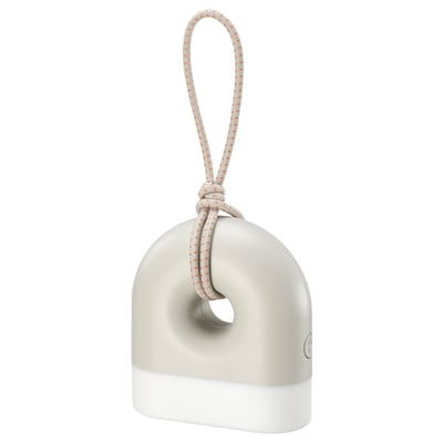 A SOLVINDEN lamp, white and gray, shaped like a donut with a handle. Its designed for both indoor and outdoor use.